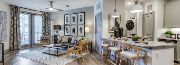 a living room with a kitchen and a dining table