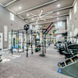 A gym with a variety of equipment including weights and machines.