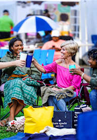 a group of people sitting on the grass