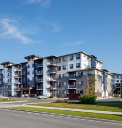 a picture of an apartment building with a blue sky in the background