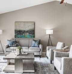 a living room with couches chairs and a coffee table