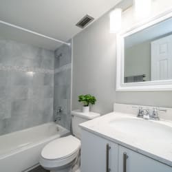 a bathroom with a white sink and toilet next to a bathtub with a shower curtain at Piper Village West, Florida