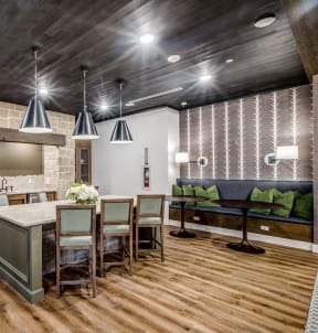 a kitchen with a large center island with a breakfast bar and a living room with a couch