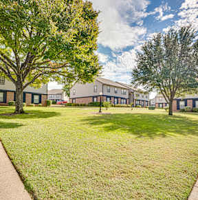 courtyard space with green grass and building exteriors at Arbors Of Cleburne, Texas