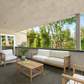 a patio with a white couch and chairs and a wooden coffee table at Orange Grove Circle, Pasadena, CA,91105