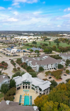 an aerial view of a neighborhood with houses and cars on the street