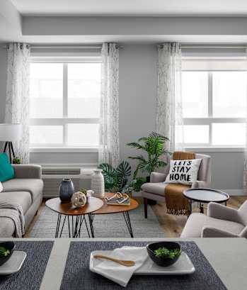 a living room with gray walls and a large window