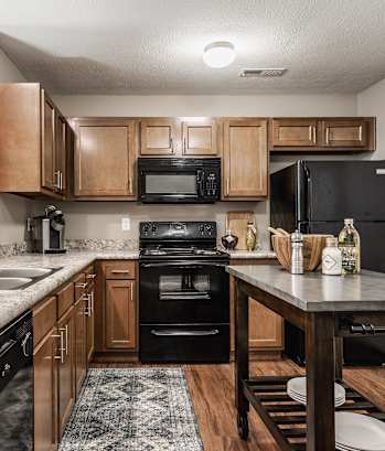 a kitchen with wooden cabinets and granite countertops