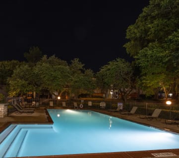 a pool at night with a view of the stars