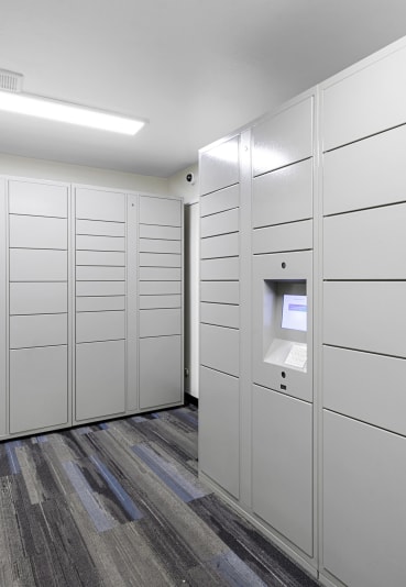 a row of white lockers in a room with a wooden floor at Willows Court Apartment Homes, Seattle