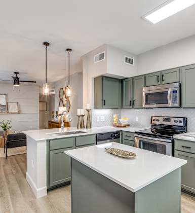 A modern kitchen with a large island in the center.