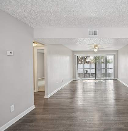 A long hallway with a door on the left and a door on the right.