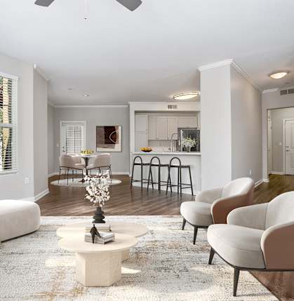 A living room with a white couch, a coffee table, and a dining table with chairs.