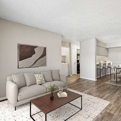 A living room with a grey couch and a coffee table.