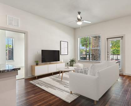 an open living room with a couch and a tv
