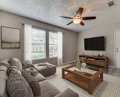 A living room with a brown sofa and a wooden coffee table.