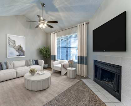 A living room with a fireplace and a television.