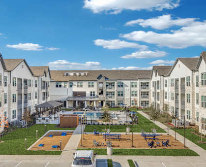 an aerial view of an apartment complex with a basketball court and a pool