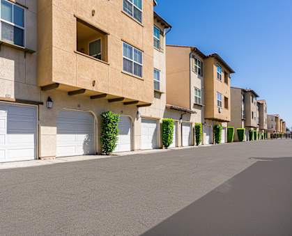 a row of apartment buildings with garages
