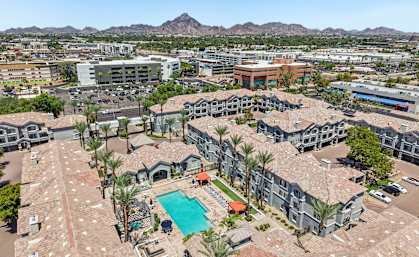 A large complex with a pool in the middle.