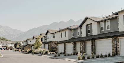 a row of houses with mountains in the background