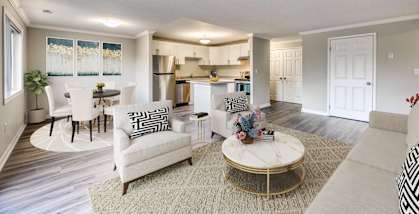a living room with a couch and a chair in front of a table with a chair and