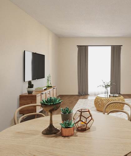 A living room with a wooden table and chairs, a couch, and a TV on the wall.