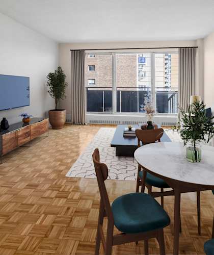A living room with a round table and chairs.
