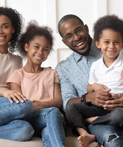 a family sitting on a couch