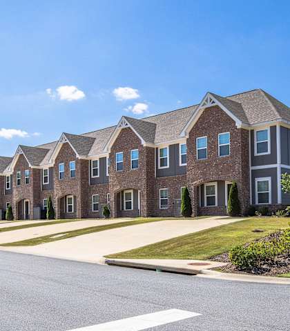 A row of houses with a street in front.