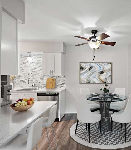 a dining room with a table and chairs and a ceiling fan