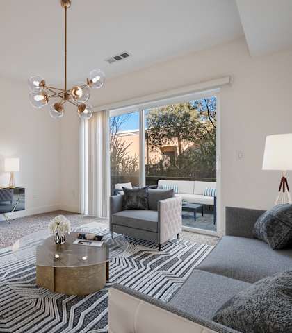 A modern living room with a zebra print rug and a coffee table in the center.