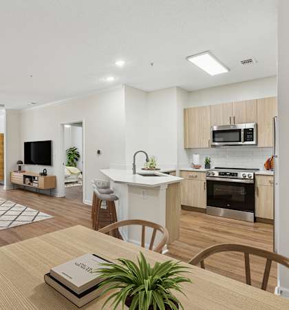 A modern open plan living and kitchen area with a dining table and chairs.