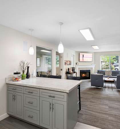 a kitchen with a large island and a living room in the background at Willows Court Apartment Homes, Seattle, 98125