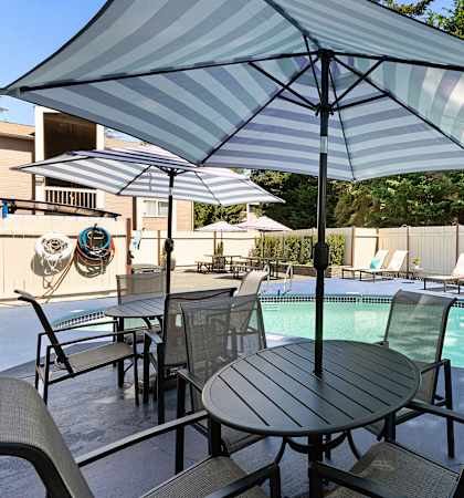 Unique Swimming Pool with Table, Chairs, and Umbrella at Park 210 Apartment Homes, Edmonds, WA, 98026