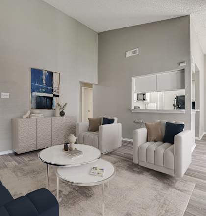 A living room with a dark blue sofa and a white coffee table.