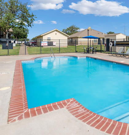 A small pool with a red brick border.