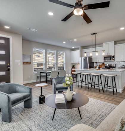 A modern living room with a grey sofa and a coffee table.