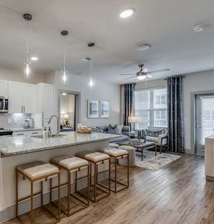 a kitchen and living room with an island and stools