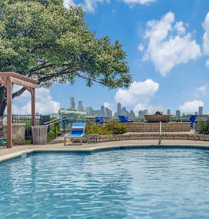 a pool with a view of the city in the background