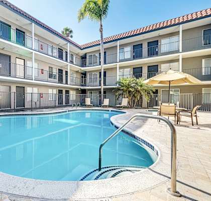 A swimming pool in a courtyard surrounded by apartment buildings.