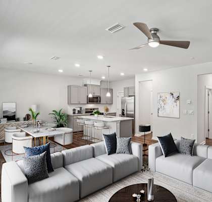 an open living room and kitchen with couches and a table