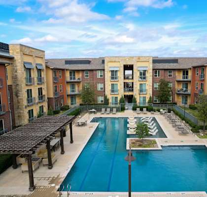 an aerial view of an apartment complex with a large pool