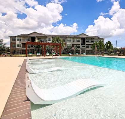 A large swimming pool in front of a building.