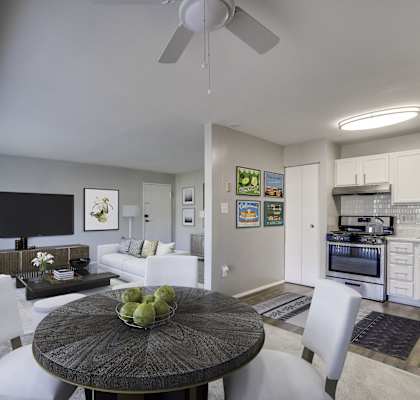 A modern kitchen with a dining table and chairs.