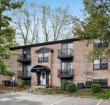 A brick building with a black awning and balconies.