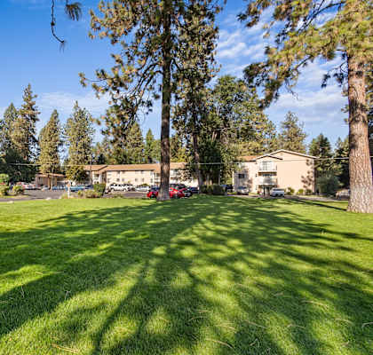 a large grassy area with a building in the background