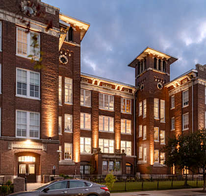 a rendering of a large brick building with a clock tower on top of it