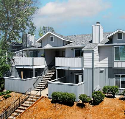 a large gray house with a gray roof