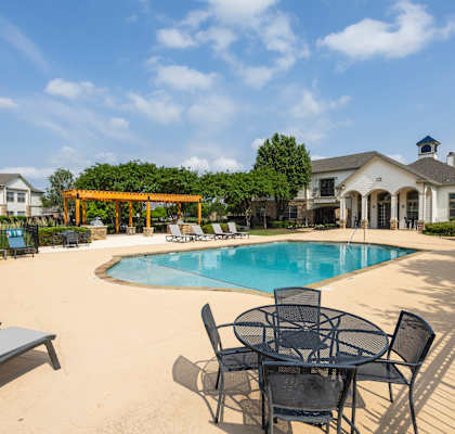 our apartments offer a swimming pool with chairs and tables